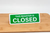 Register closed sign. Tent style sign green with white text