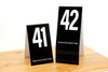 Tall black table numbers in number sequence 41-60 features a bold white number on both sides. Please place at edge of table is printed on the bottom of each number. www.citygrafx.com.