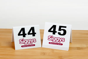 Custom printed tent style table numbers are perfect for the food service industry. Visit us at www.citygrafx.com.