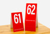 Tall tent style red table numbers in number sequence 61-80. Our red with white numbers is our most popular color and is perfect for any food service setting. www.citygrafx.com.