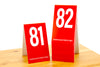 Tall tent style red table numbers are a great choice for any restaurant concept. Order online at www.citygrafx.com.